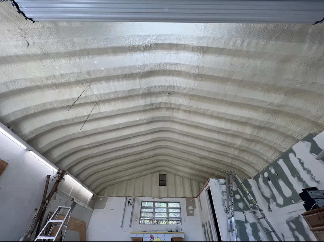 Spray polyurethane foam applied to the underside of a metal roof deck in Belmont